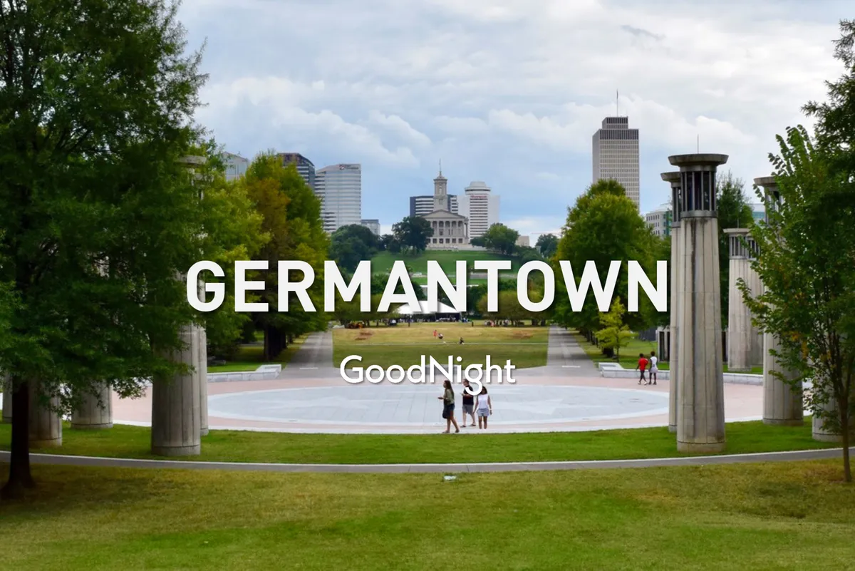 A wide view of a vibrant city park filled with people enjoying walking paths, picnicking, and socializing amid open green spaces and mature trees. The skyline forms a scenic backdrop, emphasizing both the communal and urban aspects of Nashville’s family life.