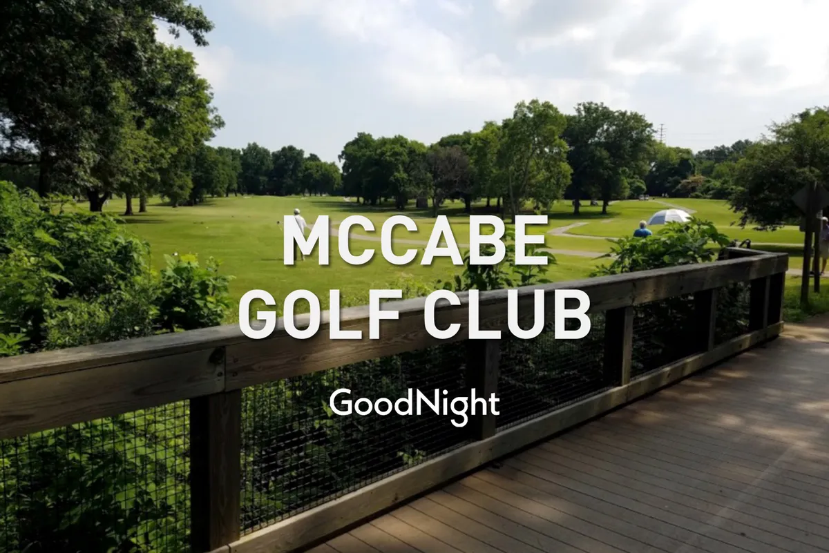 A sweeping view of a lush golf course under an open sky, with a wooden deck overlooking the green expanse and mature trees. The mood is relaxed and leisurely, perfect for a day spent golfing or socializing with friends.